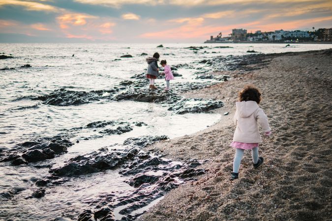 back view of little girls looking at sea