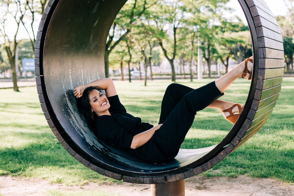 Young female relaxing on wooden round bench