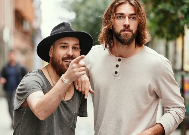 men standing in street and watching
