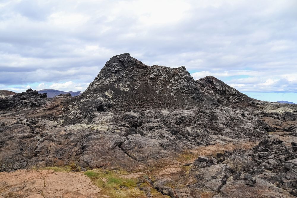 Rocky mountain with a patch of grass on the side