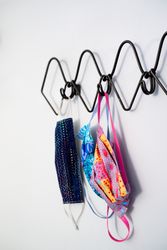 Covid masks hang on coat rack at home