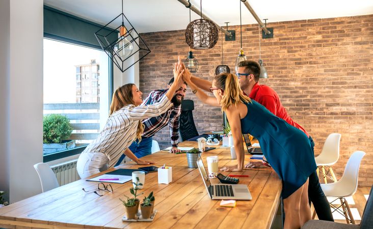 Businesspeople celebrating a success high-fiving