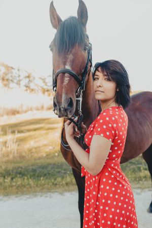 Young woman with horse on ranch
