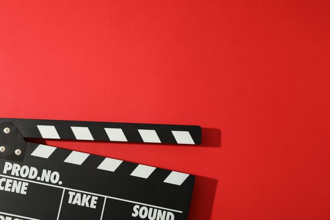 clapperboard on red background, space for text