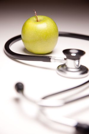Stethoscope and Green Apple on Gradated Background