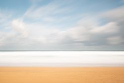 Landscape of lonely sandy seashore with cloudy sky
