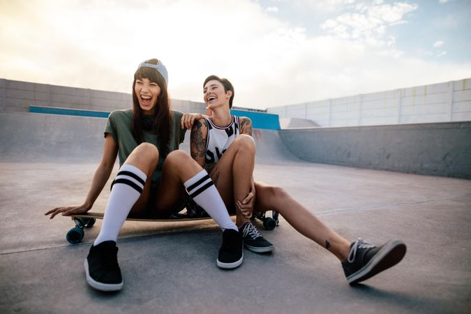 Woman skateboarders laughing and having fun