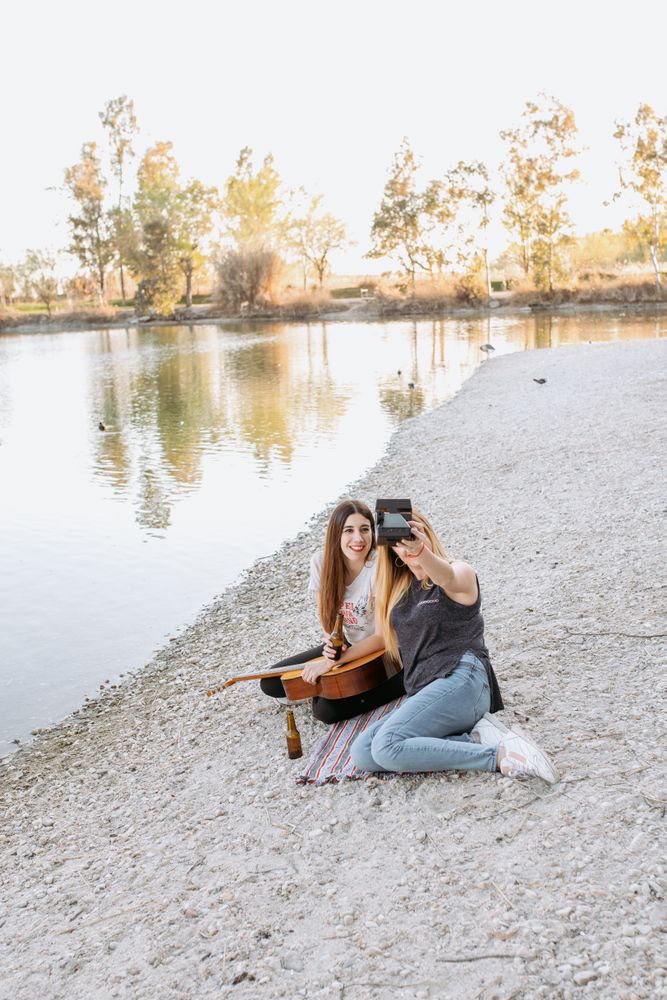 Girl friends taking selfie on beach