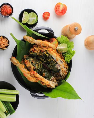 Ayam Betutu, Balinese Roast Chicken Stuffed with Cassava Leaves.
