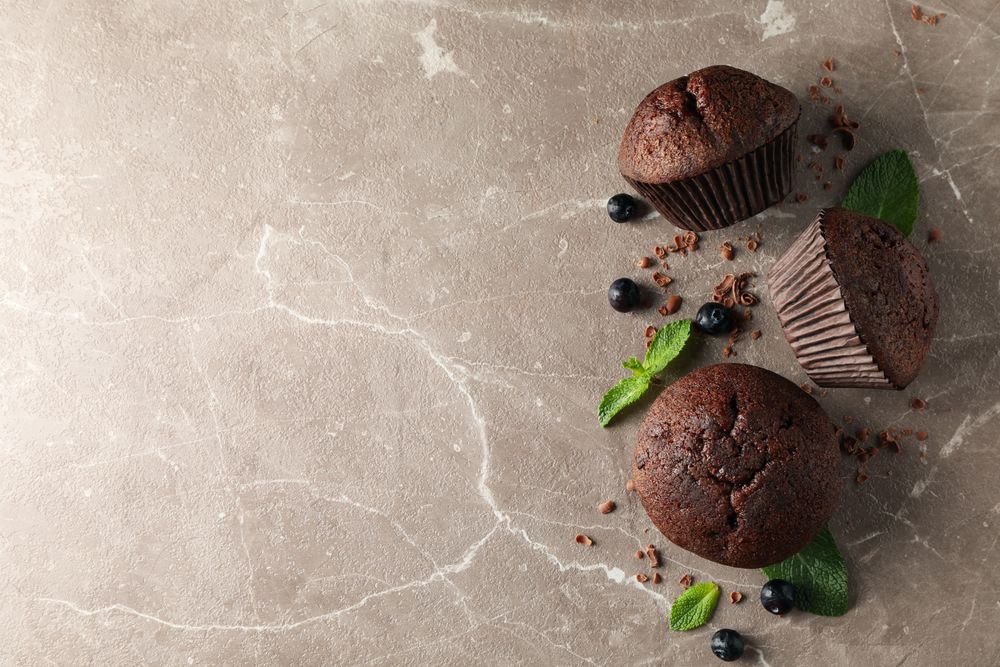 Composition with chocolate muffins on gray background