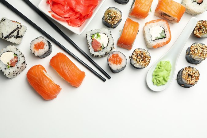 Sushi rolls and chopsticks on light background, space for text. Japanese food
