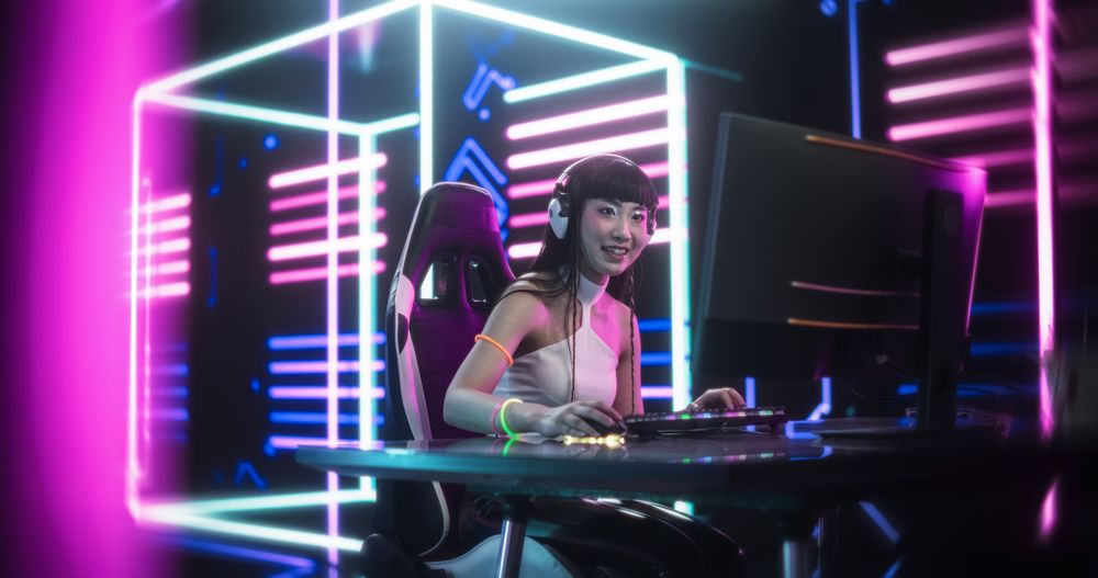 Stylish Streamer or Video Gamer Playing Games and Chatting with Internet Fans in a Futuristic Neon Studio