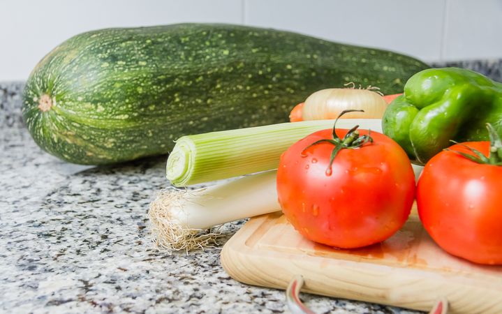 Fresh vegetables on cutting board in the kitchen