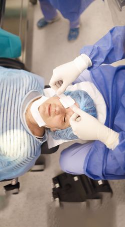 Looking down at older woman in cataract surgery