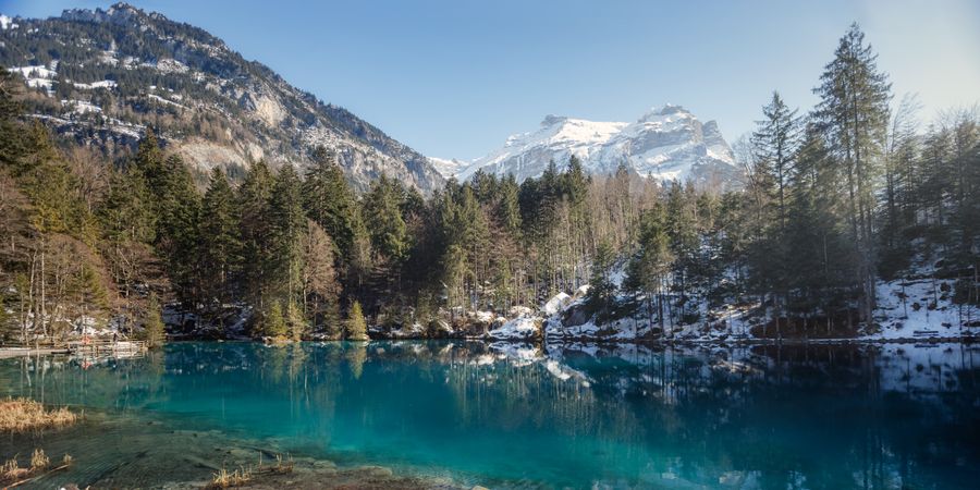 Tranquil blue lake in snowy mountains