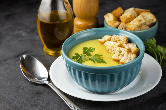 Bowl with onion soup and croutons on the table.