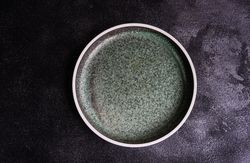 Empty grey ceramic plate table setting concept