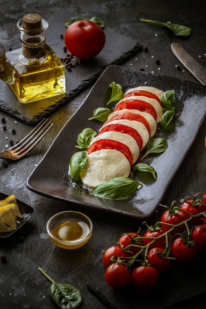 Caprese salad served on rectangular dish