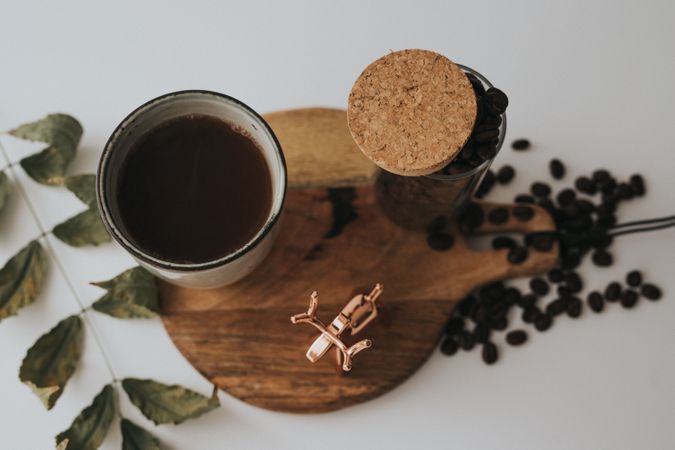 Mug and decorative elements on wooden stand on table