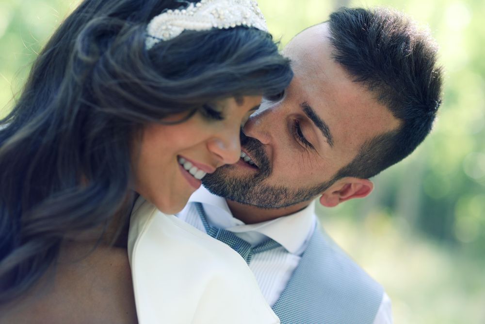 Close up of newlyweds being affectionate in forest