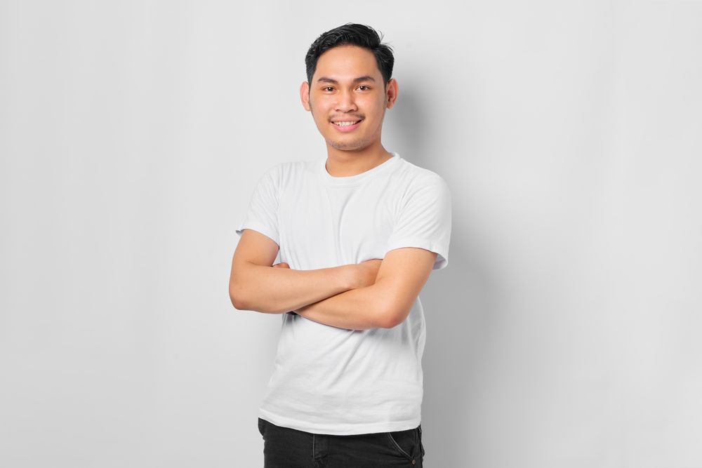 Asian male in grey studio standing tall