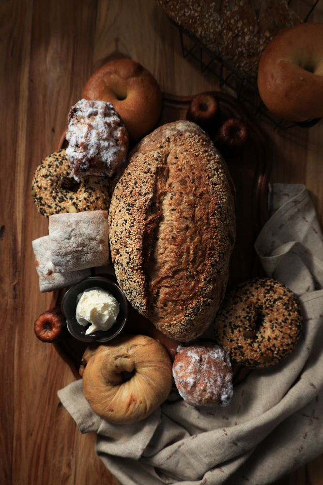 Multi Seed Sourdough with another Bakery Product on Wooden Table