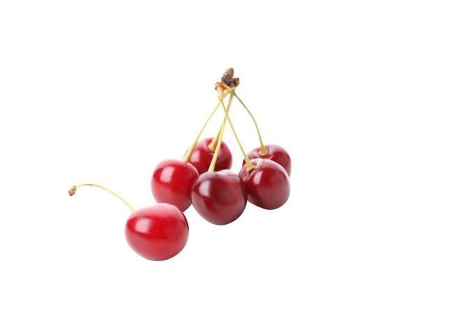 ripe cherry fruits, isolated on light background