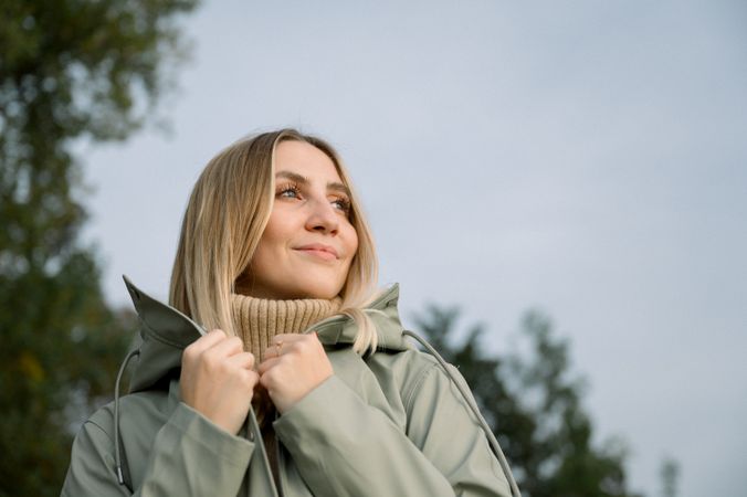 Smiling woman with hand on shoulder in park