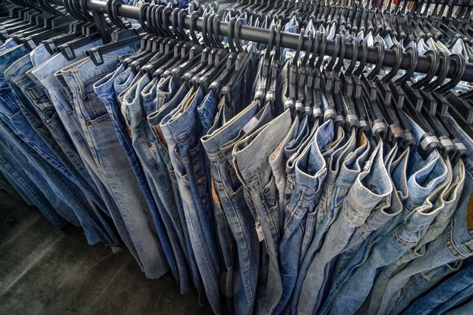 Rows of jeans on hangers