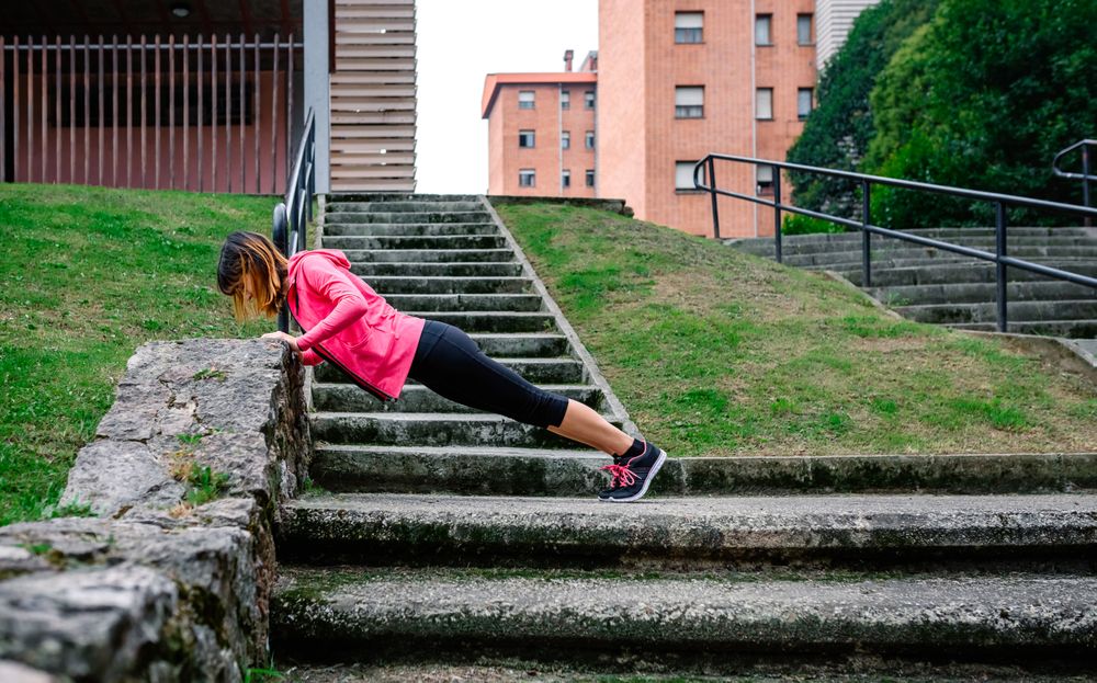 Female athlete doing push-ups outdoors
