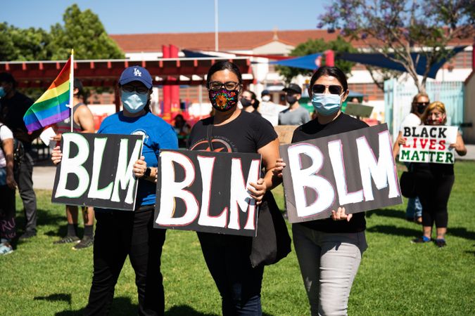 Los Angeles, CA, USA — June 7th, 2020: young Latinx women stand with BLM protest signs in East LA