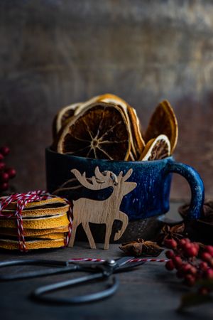 Blue mug with dried orange slices with reindeer ornament