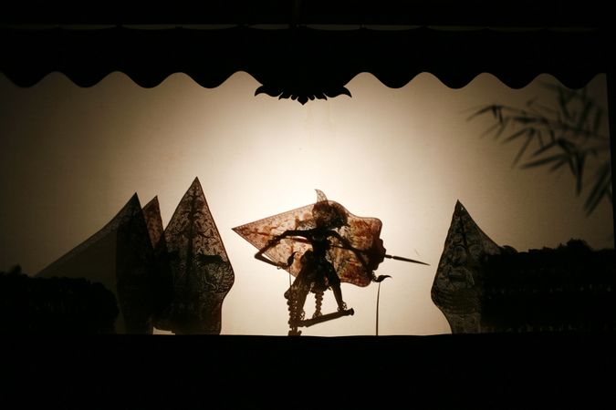 Layered shadow puppet figure with shield