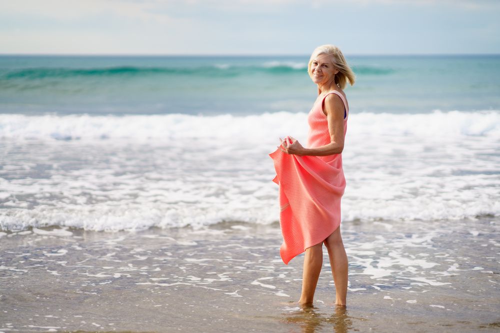 Older woman looking out to beautiful ocean