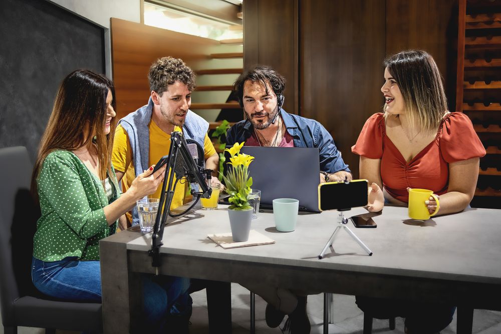 People having fun together streaming a vlog video podcast sitting in the studio