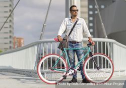 Male with bicycle on city bridge 4Omva0