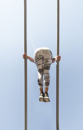 Woman training on parallel bars