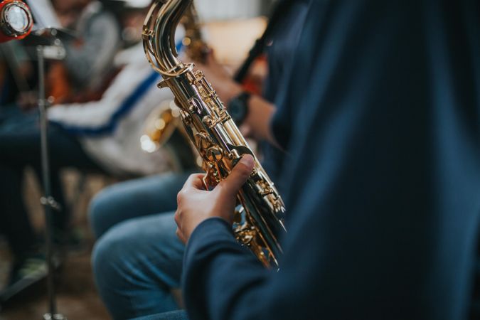 Close up of student playing the saxophone during band class