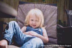Girl sitting on armchair at home 4AogE0