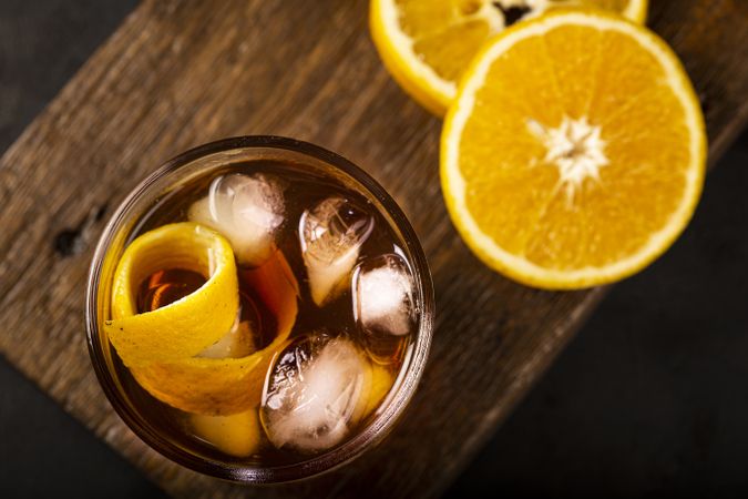 Negroni cocktail with orange, on dark background.