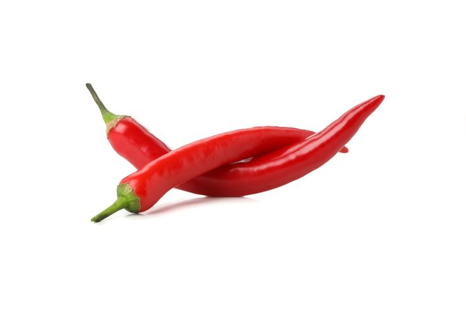 Tasty red chilli peppers isolated on blank background