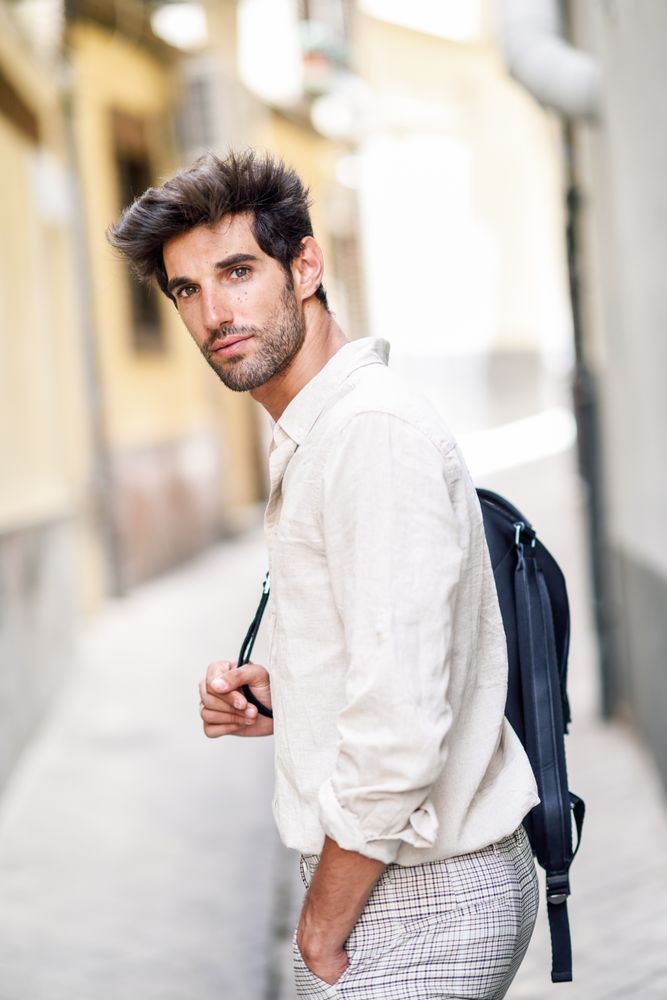 Man walking through the streets of Granada with backpack