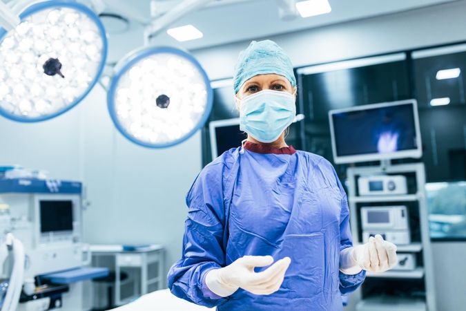Portrait of surgeon standing in operating room, ready to work on a patient