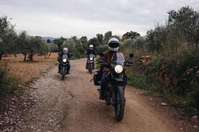 Group of friends going for a bike ride on a dirt road