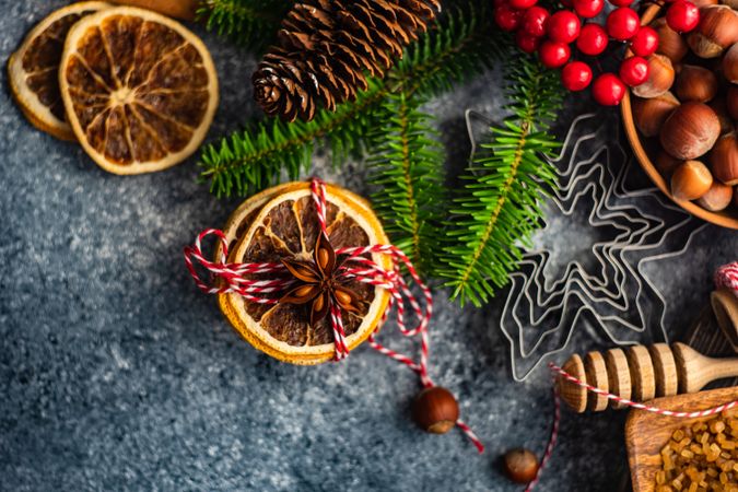 Top view of Christmas dried orange slices and branches on concrete counter