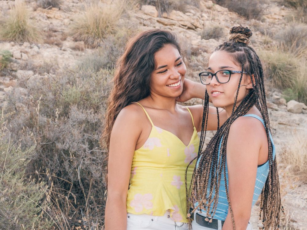 Happy trendy young women bonding at countryside
