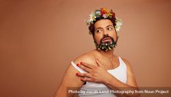 Gender fluid man wearing tank top and flowers 4N9B25