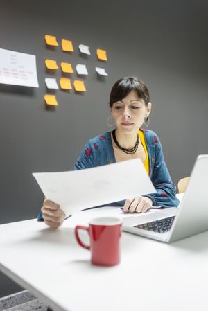 Smiling businesswoman working with documents