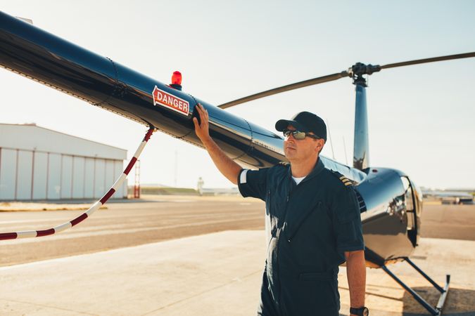 Mechanic inspecting helicopter before take off