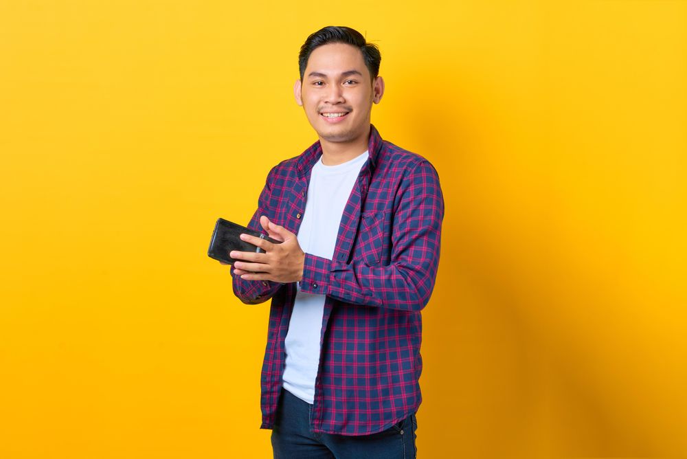 Happy man closing his wallet